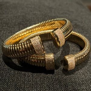 Two brand new stretch gold bracelets with stones on either end of opening